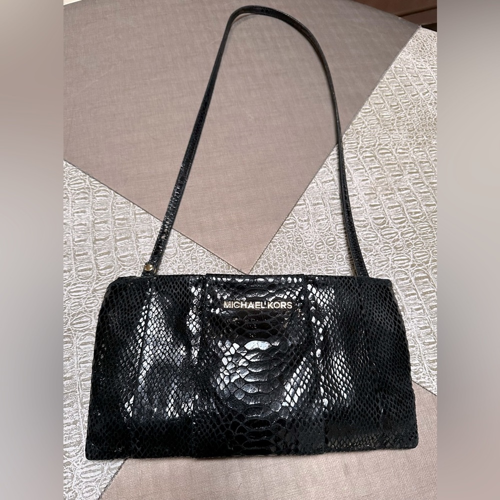 Black snake print MICHAEL Michael Kors crossbody bag with gold hardware.